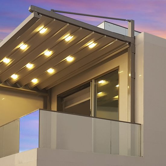 Retractable pergola with integrated lights shading a balcony at a villa in Dubai