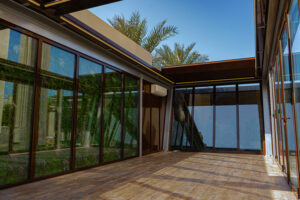 Outdoor glass room with motorized roof